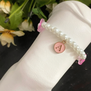 A custom made bracelet with a glittery pink butterfly charm and the letter A